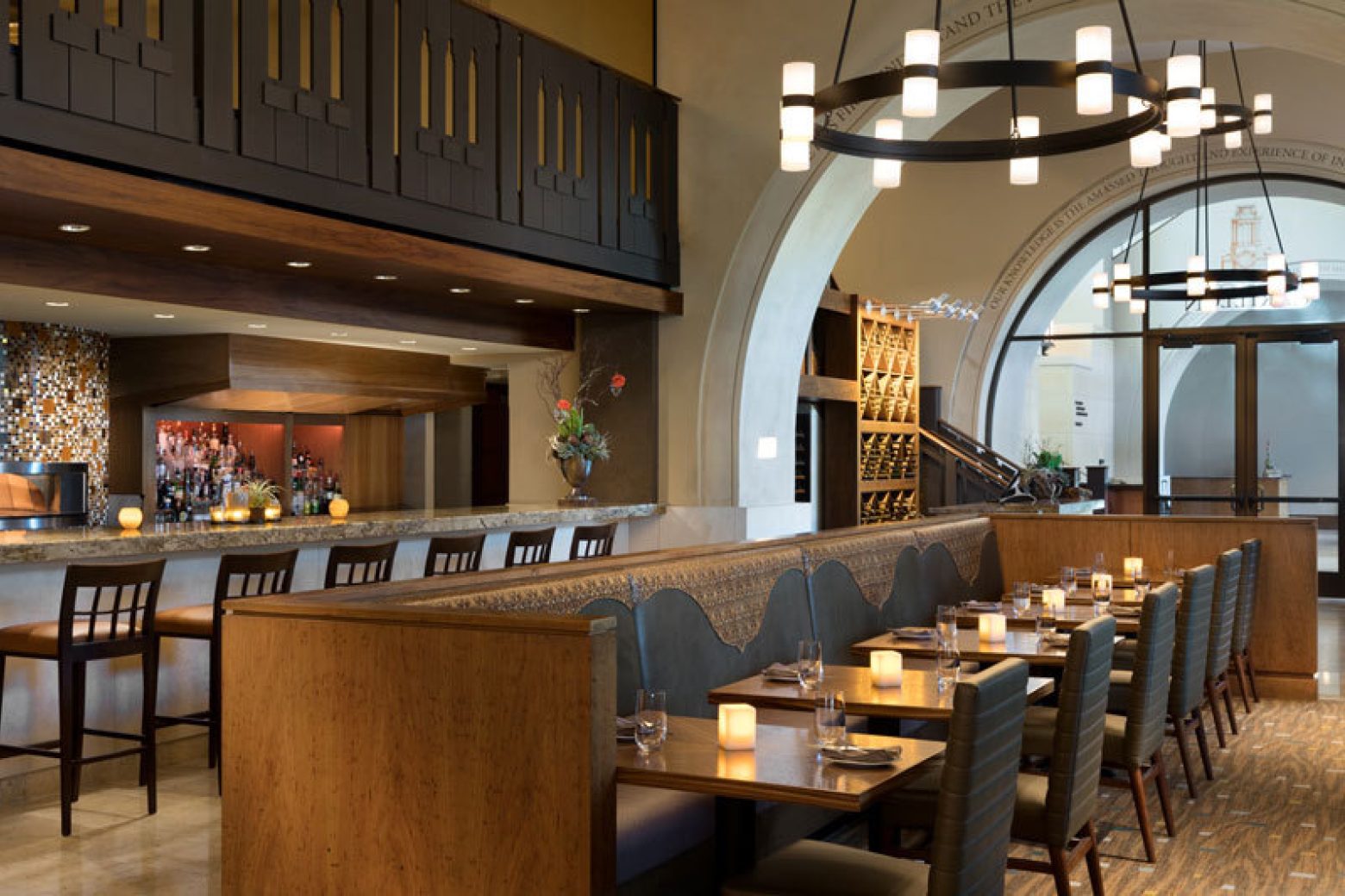 A restaurant dining area with booths and tables set for dinner.