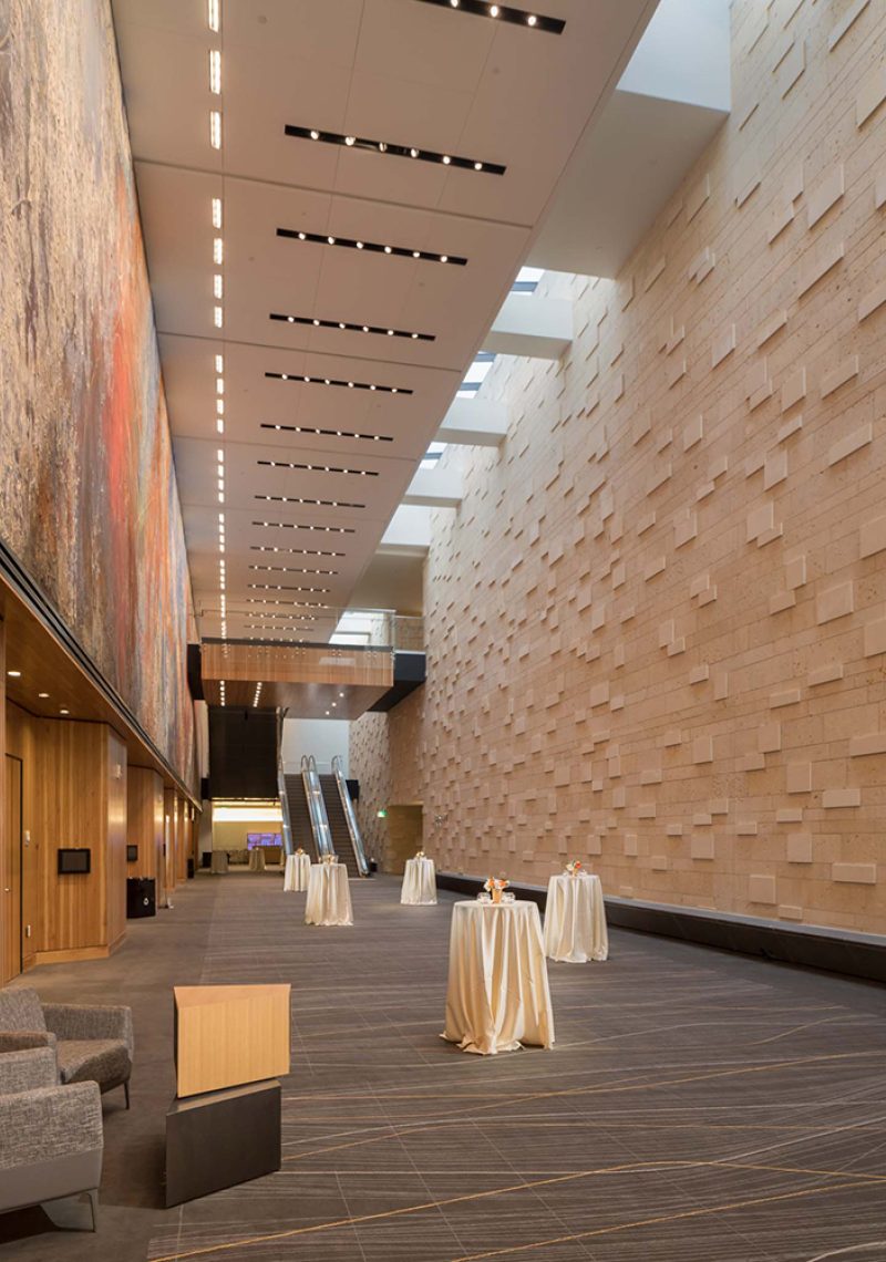 A large, open room with a high ceiling and a decorative wall.